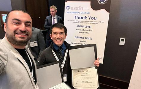 Hamid Fekri Azgomi and Kenneth Louie pose for a selfie with their poster certificates.