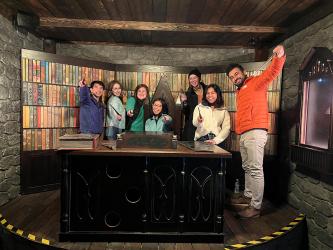 A group of people sitting behind a desk smiling