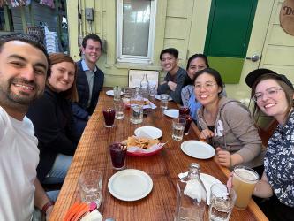 A group of people sitting at a table with chips and drinks.