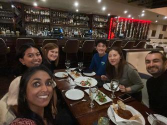 A group of people sitting at a dinner table in a restaurant.